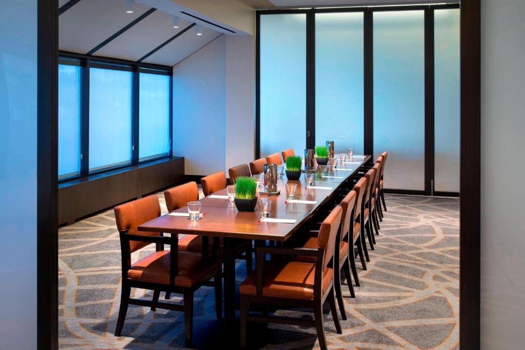 a long dining room with a long table and chairs at Newark Liberty International Airport Marriott in Newark