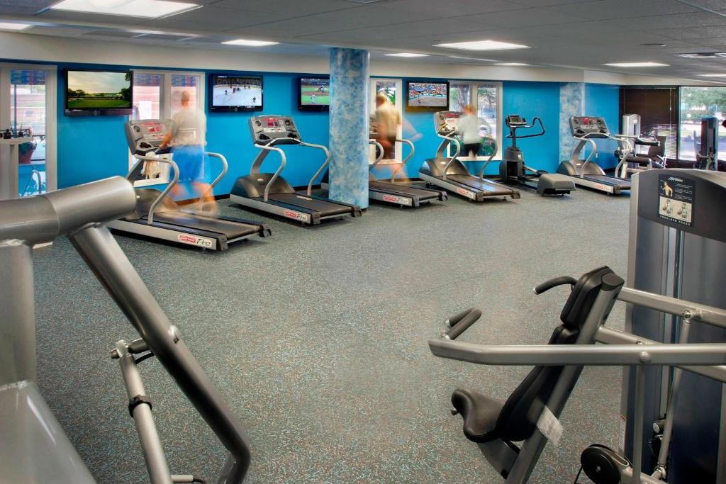 a gym with rows of treadmills and machines at Newark Liberty International Airport Marriott in Newark
