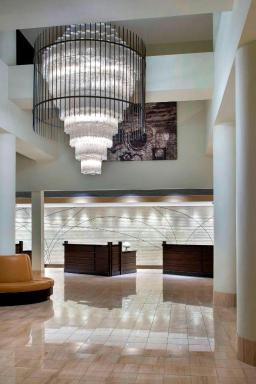a large lobby with a large chandelier in a building at Newark Liberty International Airport Marriott in Newark