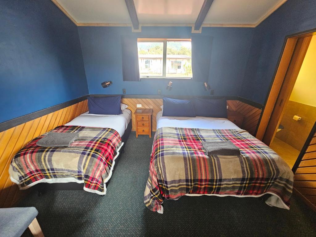 Voodi või voodid majutusasutuse Chateau Backpackers & Motels toas
