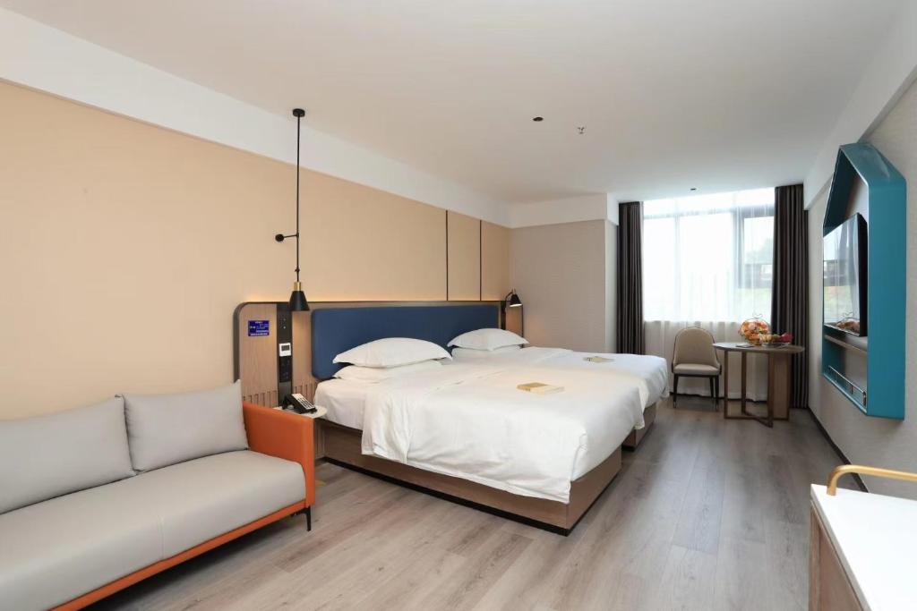 Postel nebo postele na pokoji v ubytování Guangzhou Yilin Hotel - Xiaogang metro Store