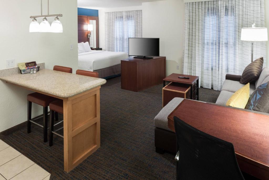 a hotel room with a bed and a living room at Residence Inn Boston Marlborough in Marlborough