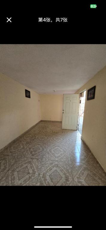 an empty room with a door and a tile floor at zhen in Mexico City