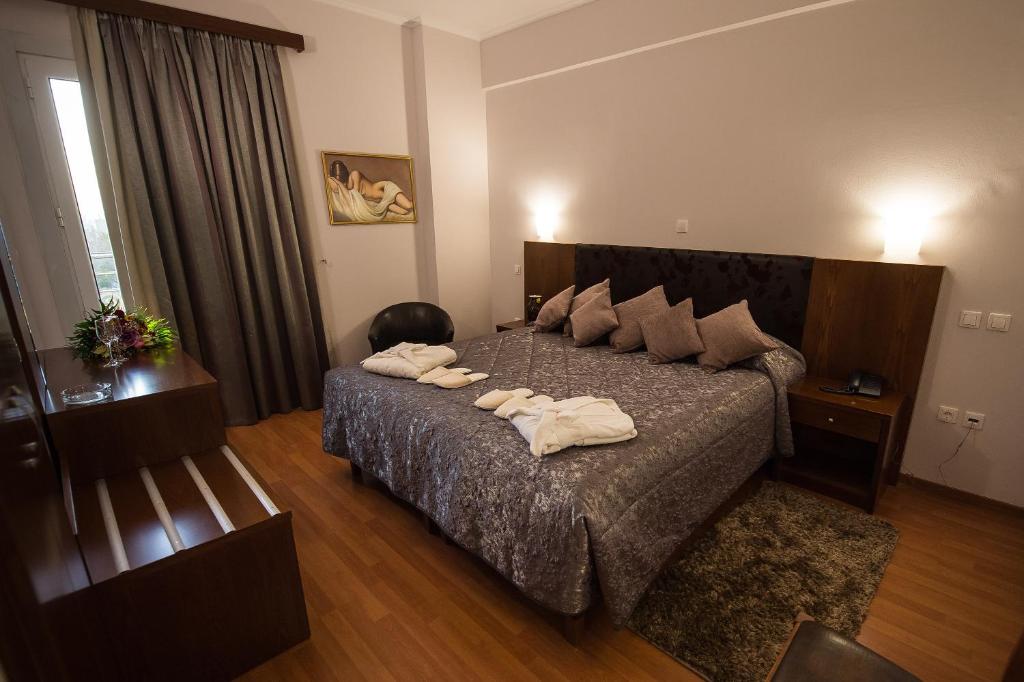 Postel nebo postele na pokoji v ubytování Hotel Olympos