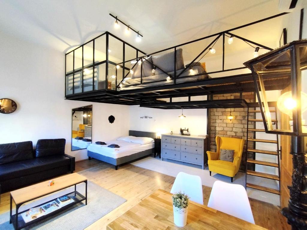 a loft apartment with a bed and a bunk room at MOOKI Rumbach Budapest Apartment in Budapest