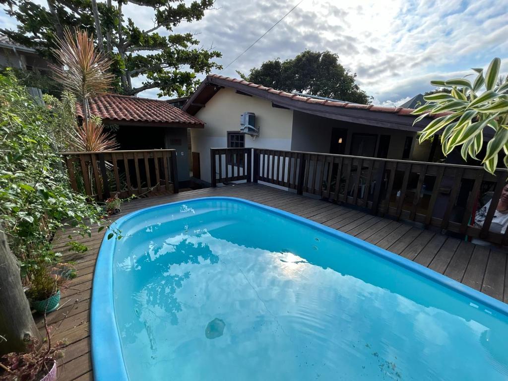 a pool on the deck of a house at Casa privativa com piscina na Praia da Ferrugem duas quadras mar REF 100 in Garopaba
