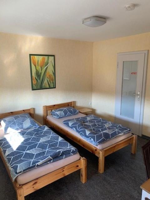 two beds sitting next to each other in a room at Monteurpension Haus Monika in Marktheidenfeld