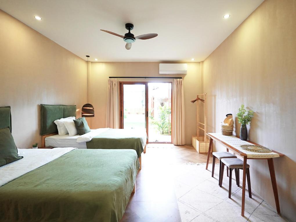 Postel nebo postele na pokoji v ubytování Kalachuchi Inn 薄荷雞蛋花旅宿