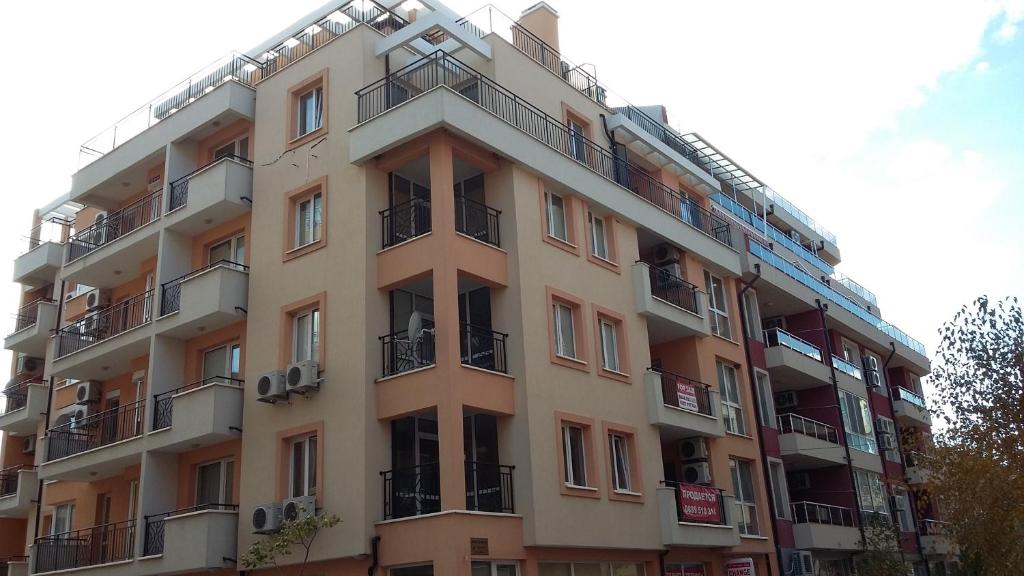 a tall building with balconies on the side of it at Zefira Apartments in Pomorie
