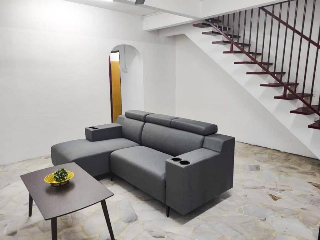 a living room with a couch and a table at SK Sweet Homestay SP Kedah in Sungai Petani