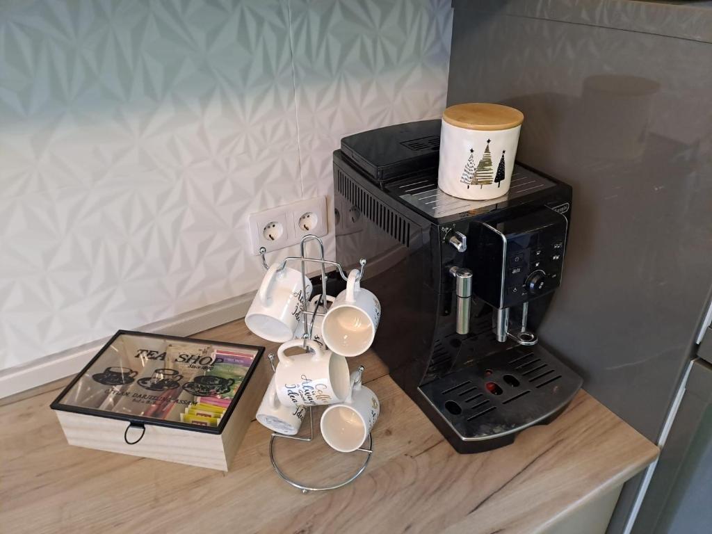 a counter with a coffee maker and a coffee cup at SofiYanis in Sibiu