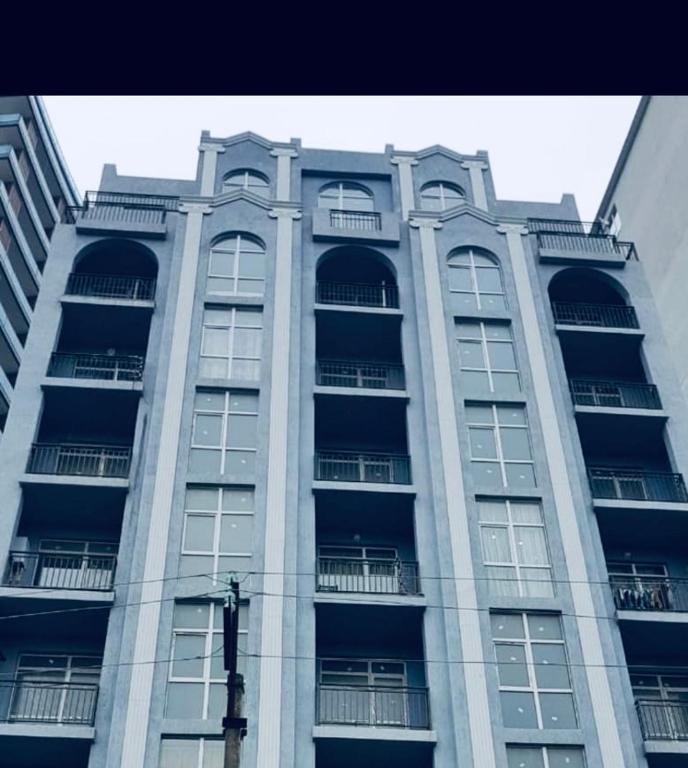 a tall building with balconies on the side of it at Apartament in Batumi