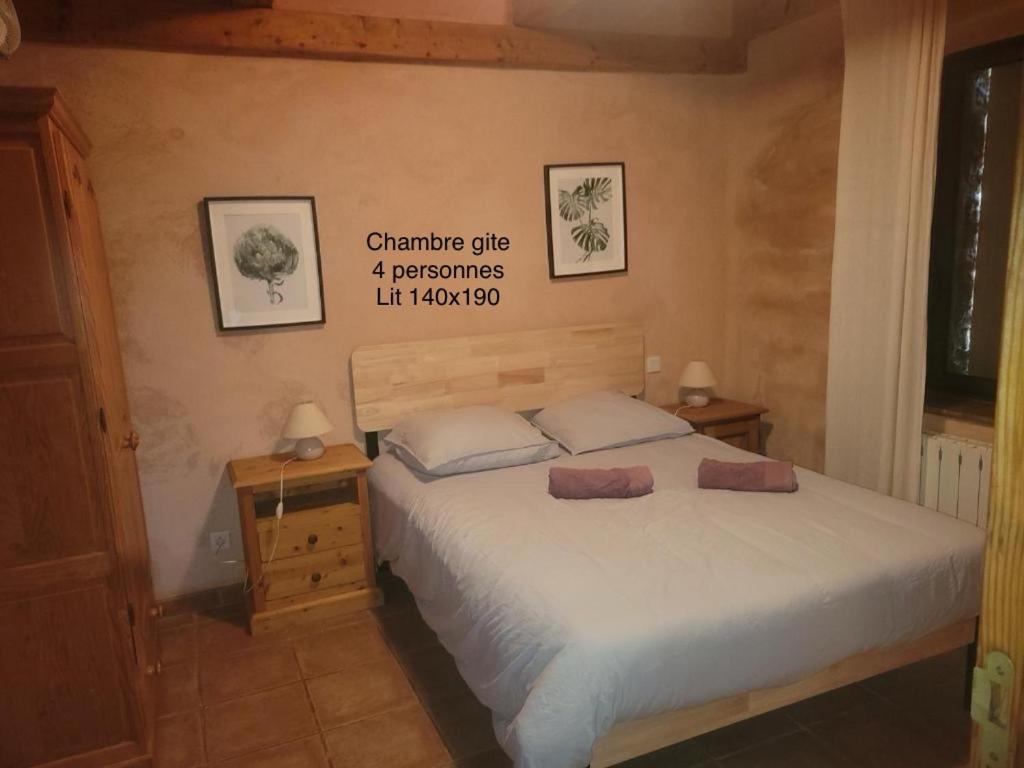 a bedroom with a bed with two pillows on it at Mas De Sarjac in Saint-Andéol-de-Vals