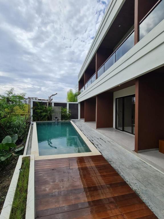 a swimming pool in the backyard of a house at DKD ROOM Pererenan Canggu in Canggu
