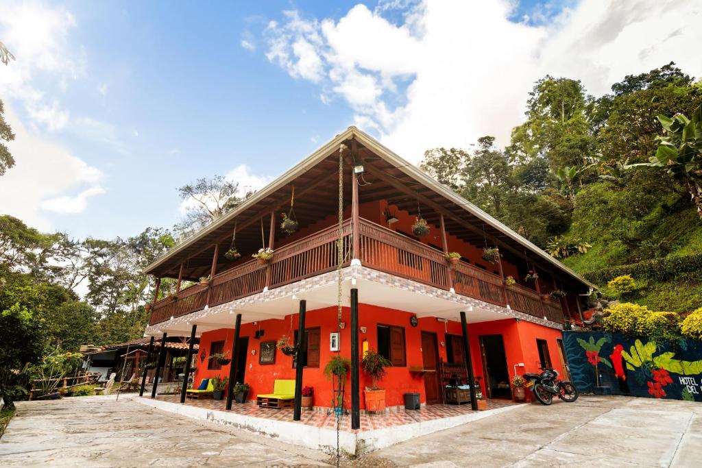 an orange building with a roof at Hotel Orillas del Pizano in Jardin