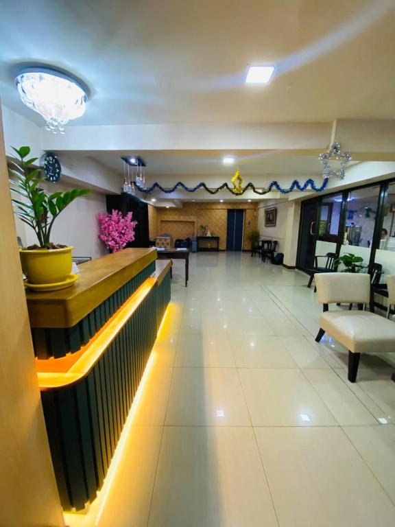 a lobby with a waiting area with tables and chairs at Residency Hotel Bangkok in Bangkok