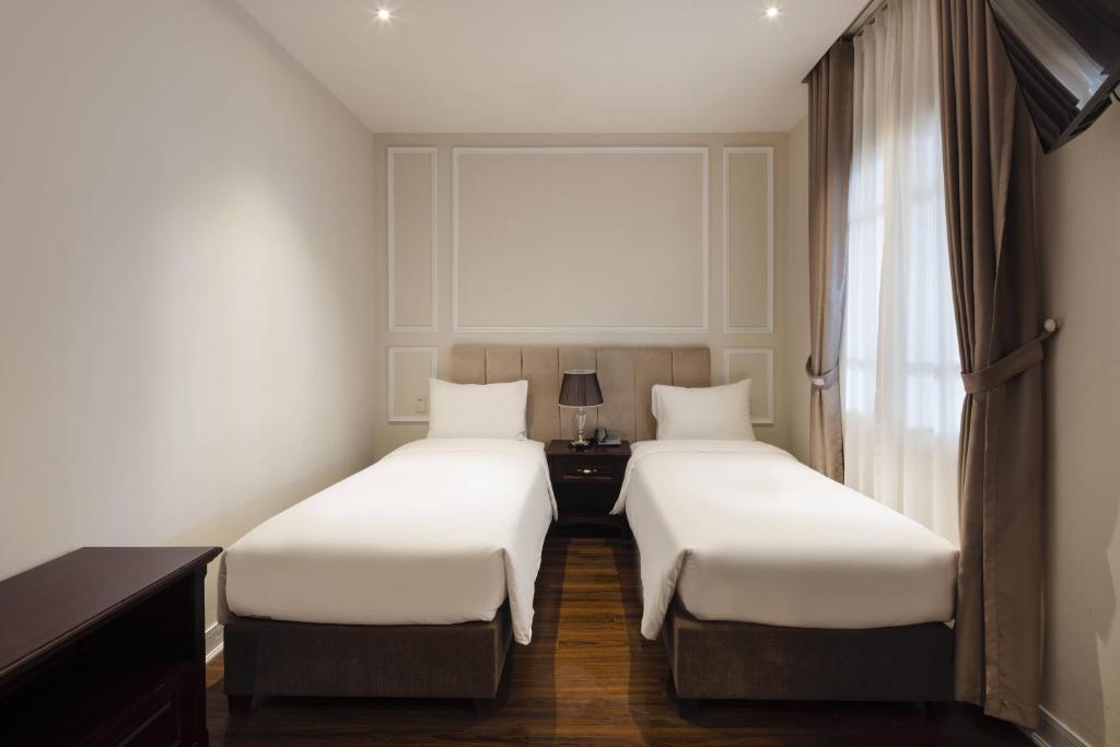 Postel nebo postele na pokoji v ubytování Maro Hotel & Apartment