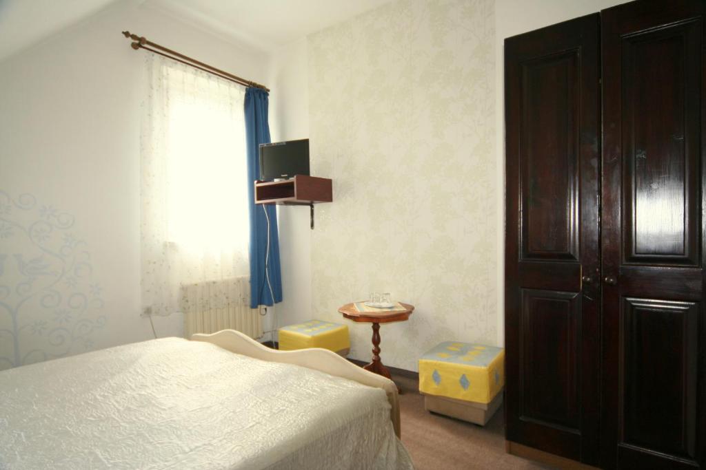 a bedroom with a bed and a dresser and a window at Diamant in Karlovy Vary