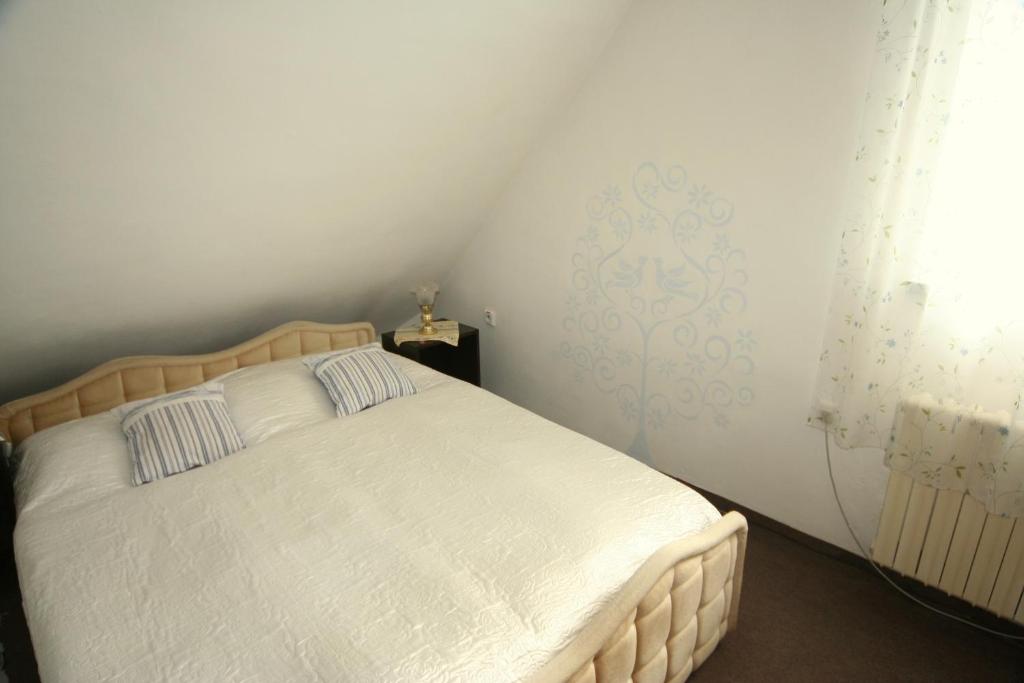a bedroom with a bed with white sheets at Diamant in Karlovy Vary