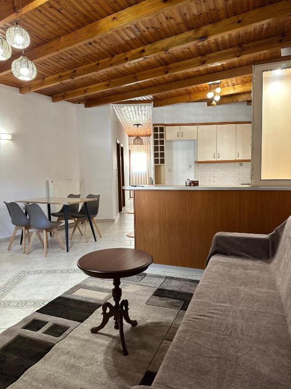 a living room with a couch and a table at Koutsogiannopoulos House in Kalavrita