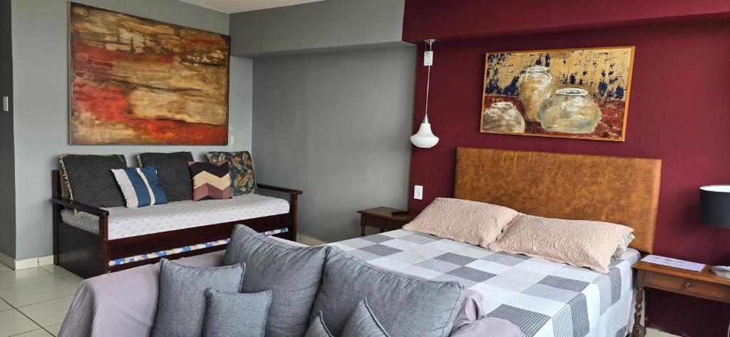 a living room with a bed and a couch at Edifício Mirante do Vale in Sao Paulo