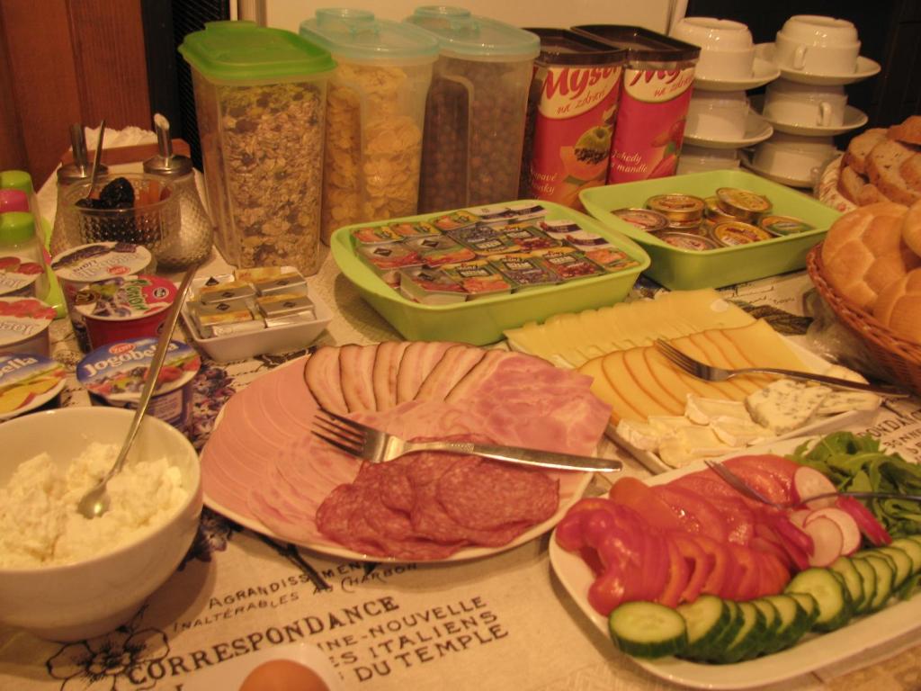 a table topped with plates of food and other foods at Diamant in Karlovy Vary