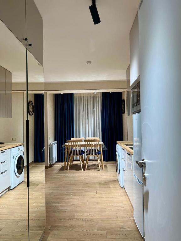 a kitchen and dining room with a table and a washing machine at New Gudauri Redco F1 in Gudauri
