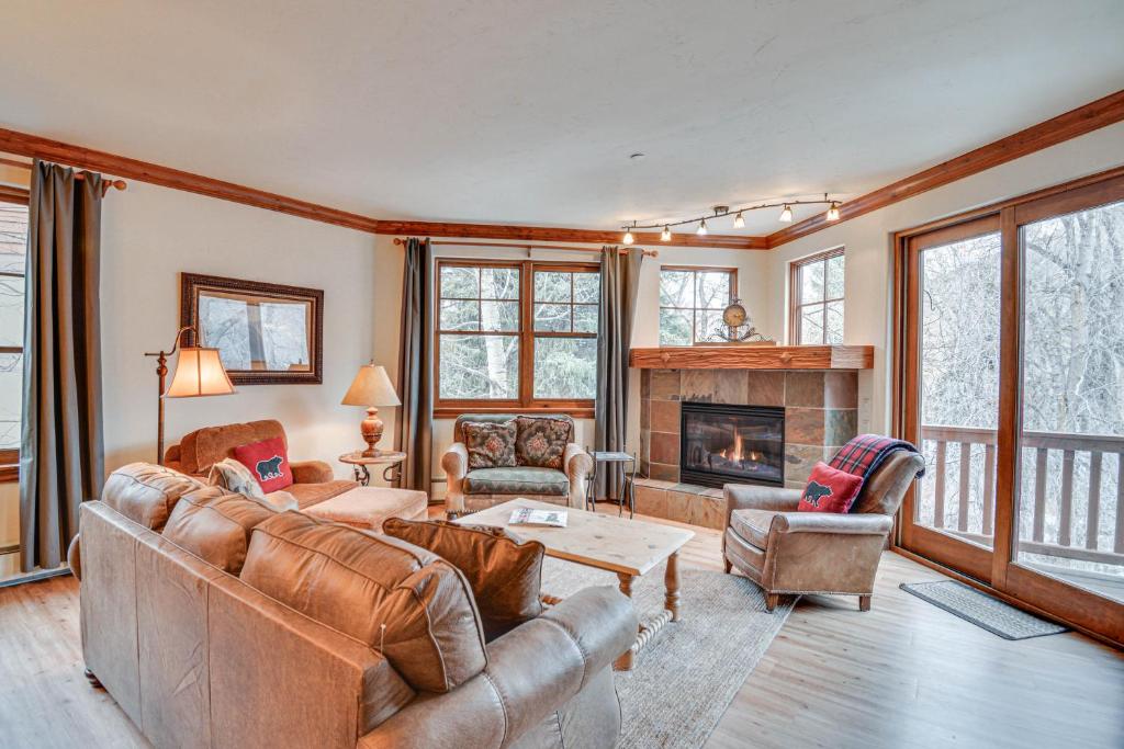 a living room with leather furniture and a fireplace at Cozy Avon Retreat w/ Private Deck & Pool Access! in Avon