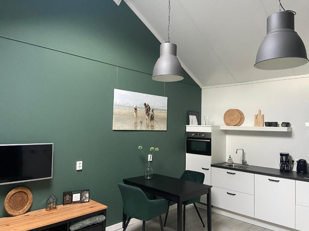 a kitchen with a table and a dining room at 2 persoons zon en zee in Westkapelle