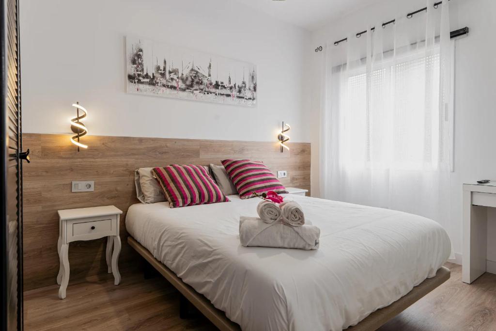 a bedroom with a large bed with two towels on it at Casa Mario Suites in Santa Cruz de Tenerife