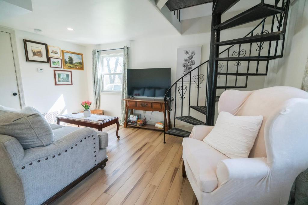 a living room with two couches and a piano at Hadley Hideaway Cottage in Hadley