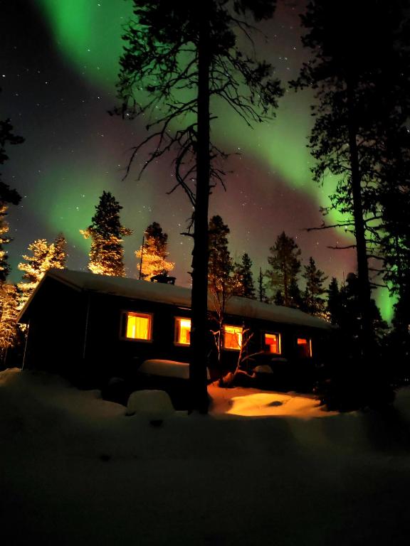 an image of a house with the aurora in the sky at Aurora Grande in Saariselka