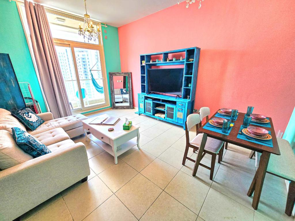 a living room with a couch and a table at Waterfront Tropical Themed 2 BR in Abu Dhabi