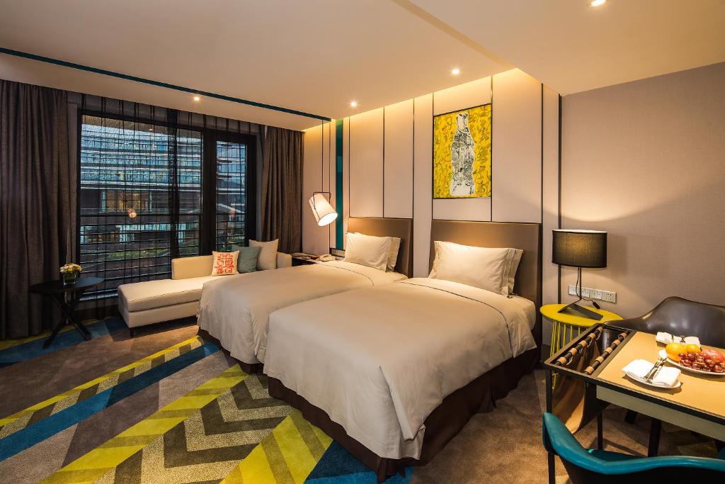 Postel nebo postele na pokoji v ubytování MiniMax Premier Hotel Shanghai Hongqiao