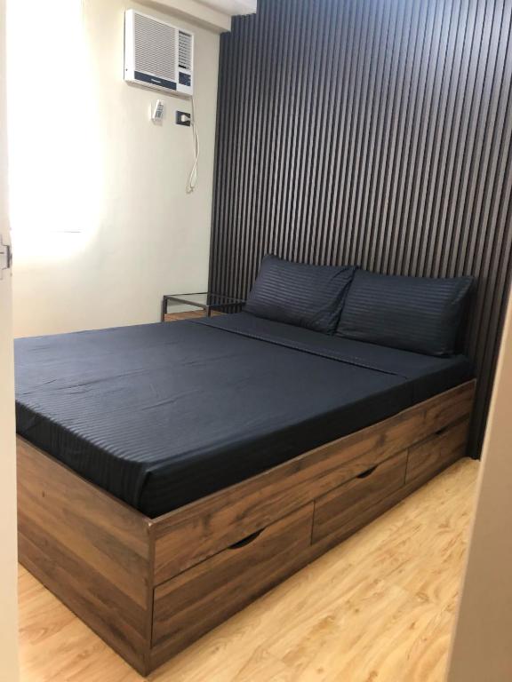 a bed in a room with a black mattress at REI365 Condotel in Davao City