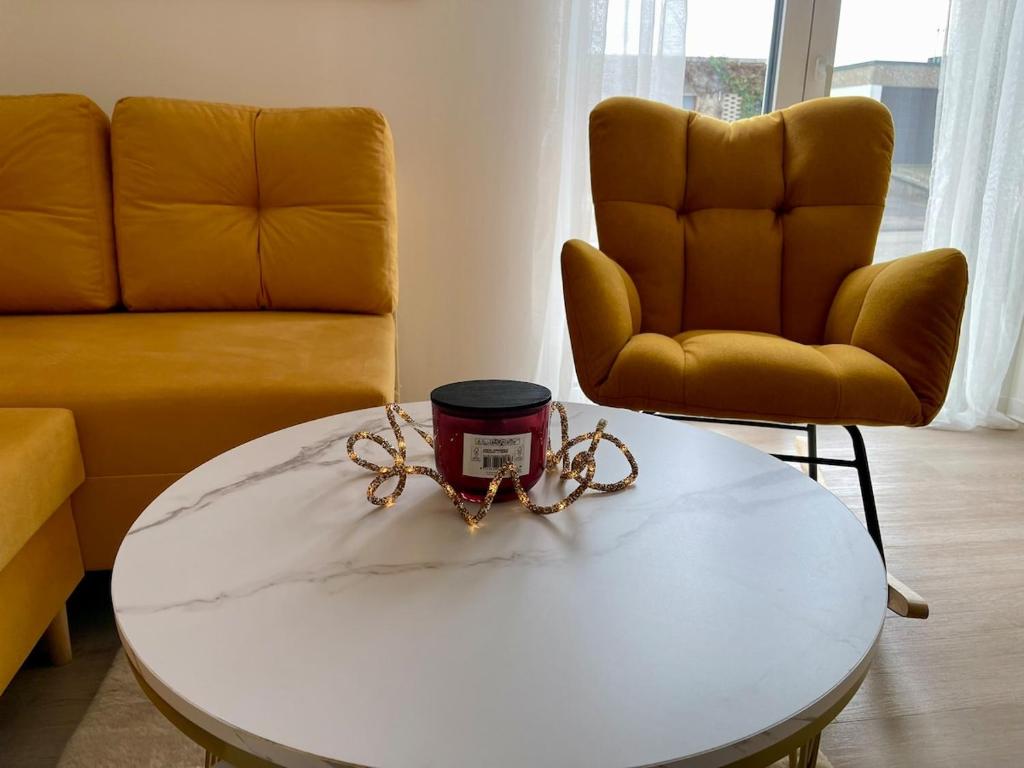 a living room with two chairs and a coffee table at Modern apartment in Albstadt