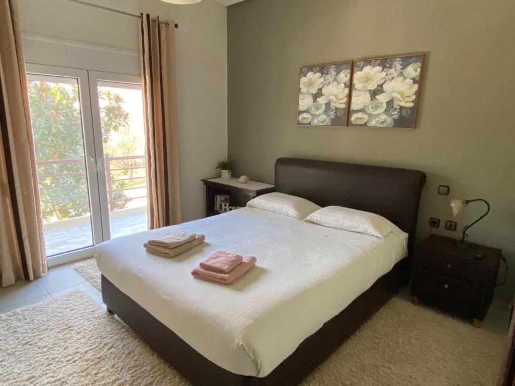 a bedroom with a bed with two towels on it at Family's home Trikala in Tríkala