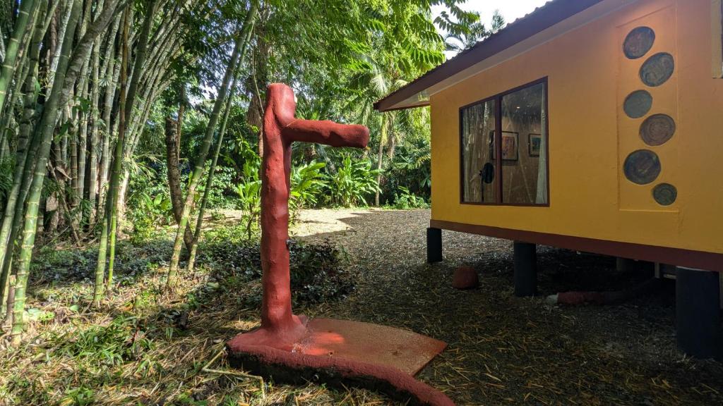 a red pipe sitting next to a tiny house at Tree House Beachfront Lodge in Puerto Viejo
