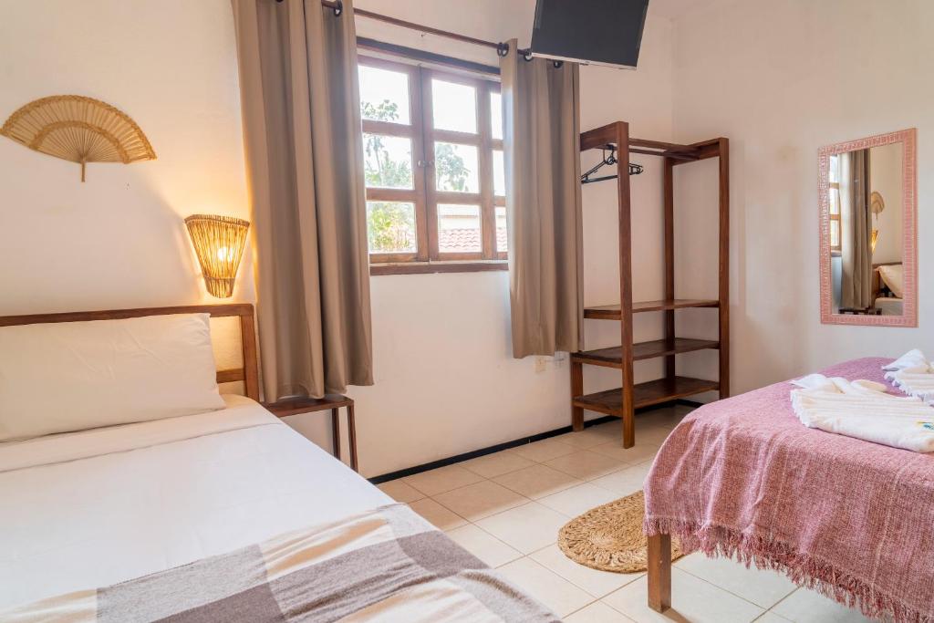 Postel nebo postele na pokoji v ubytování Pousada Villa Tomasi