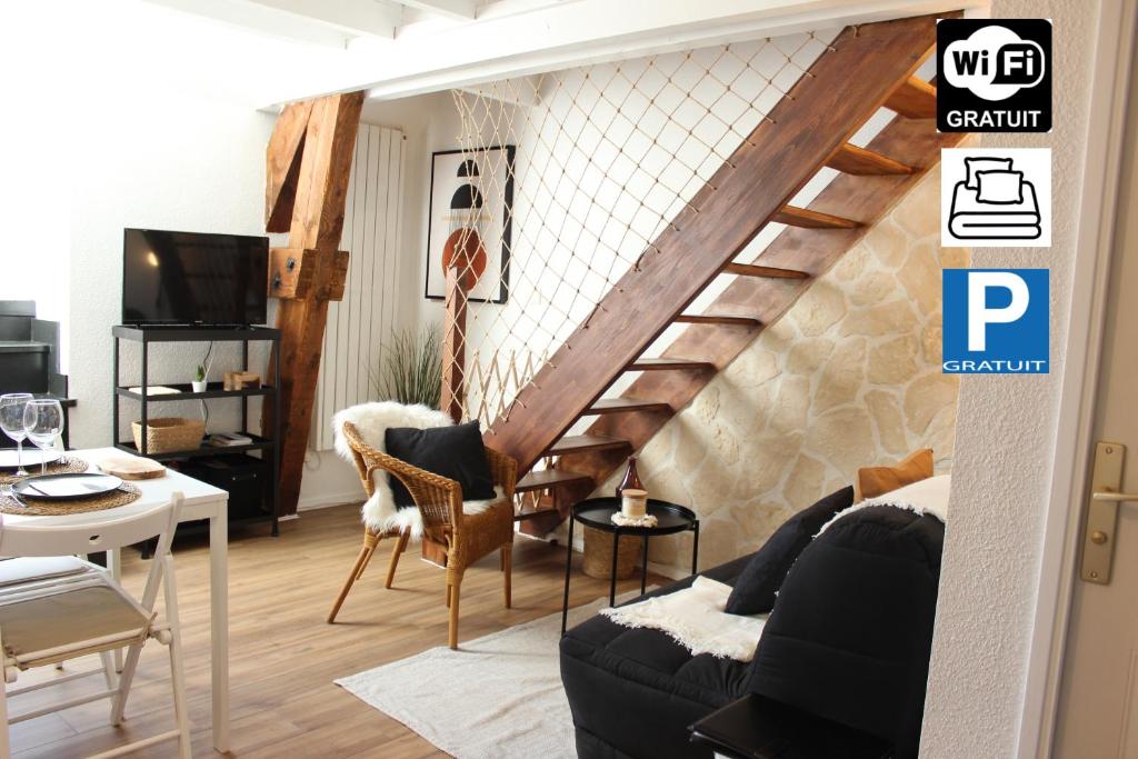 a living room with a staircase in the wall at Le 41 - Cosy et Confort in Barèges