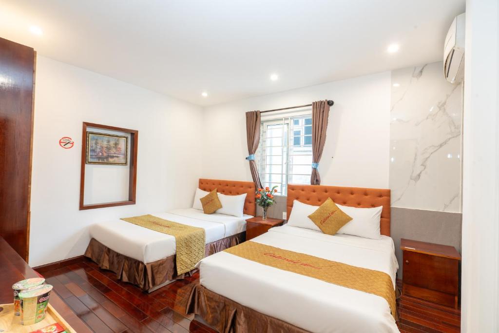 Postel nebo postele na pokoji v ubytování Danang Catinal Riverside Hotel