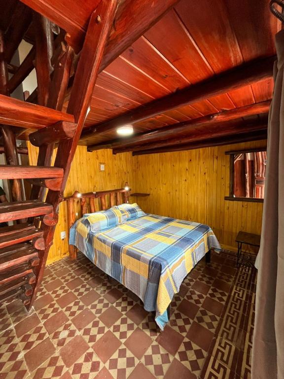 a bedroom with a bed in a room with wooden ceilings at Dulce Claudina 2 in Mercedes