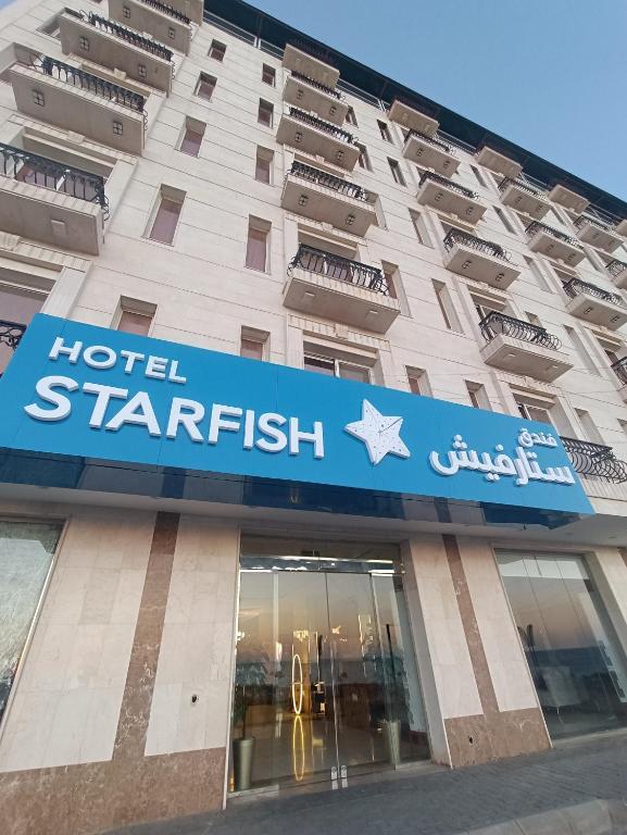 a hotel starfish sign on the front of a building at فندق ستارفيش الحوراء الفندقية in Umm Lajj