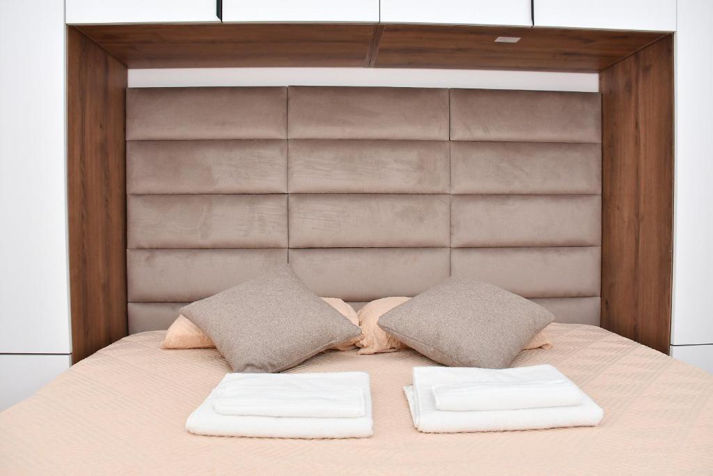 a bedroom with a bed with two pillows on it at Apartman Kragujevac in Kragujevac