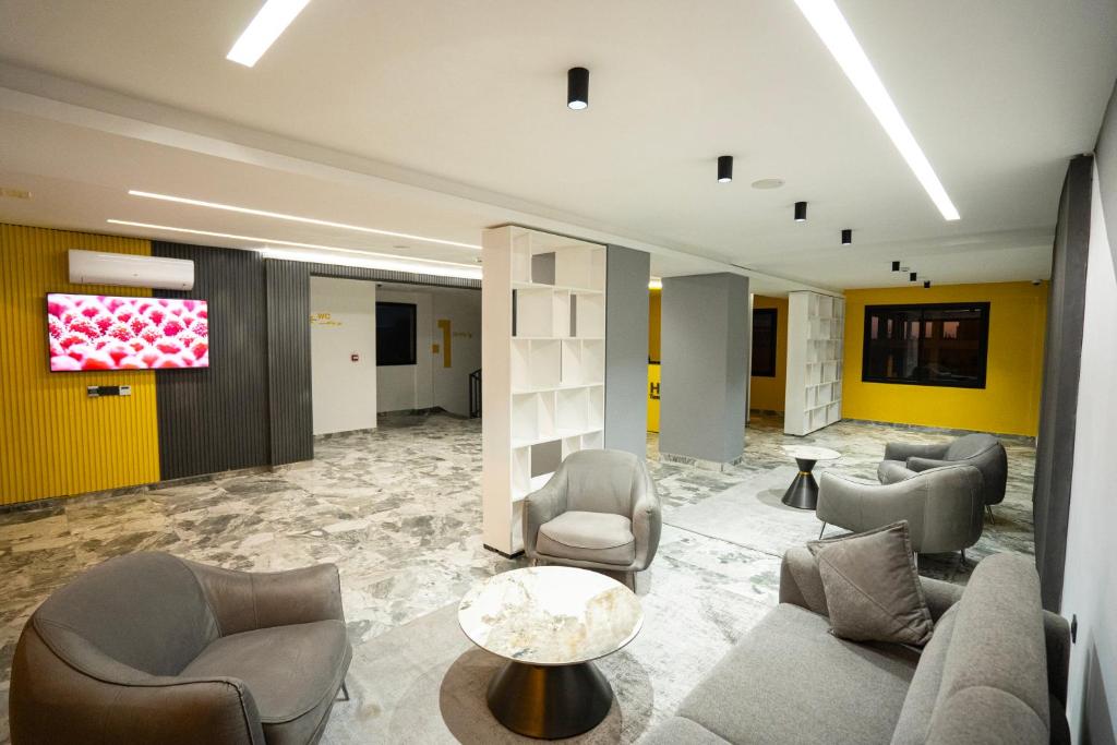 a lobby with couches and chairs and a table at Hotel STAY INN in Agadir
