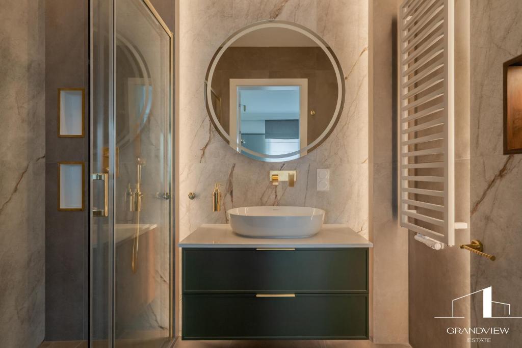 a bathroom with a sink and a mirror at Penthouse Brabank Luxury Green Sauna&Fitness Free Parking by Grandview in Gdańsk
