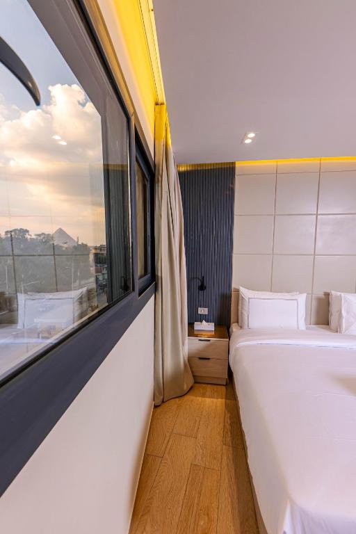 Postel nebo postele na pokoji v ubytování Remal Pyramids Hotel