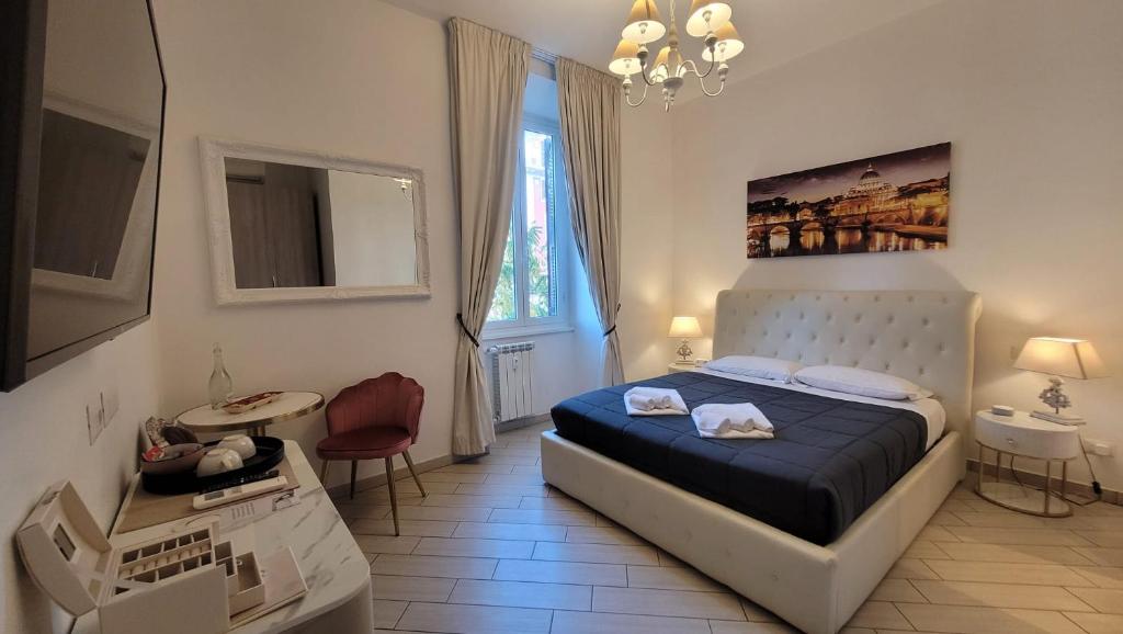 a bedroom with a bed and a table and a window at Rome Central Rooms in Rome