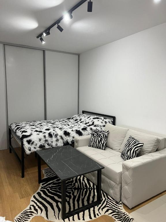 a living room with a couch and a table at Y apartman Zvezdara in Belgrade