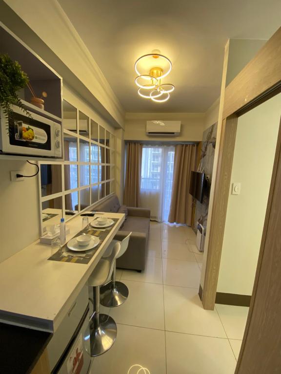 a kitchen and living room in a apartment at Aesthetic Vibes Condo 2br Near Airport in Manila